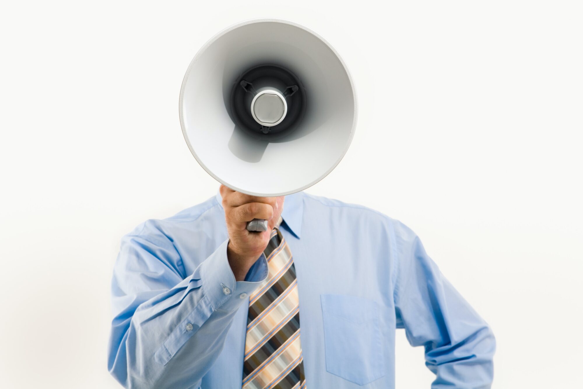 Man wearing tie shouting into megaphone