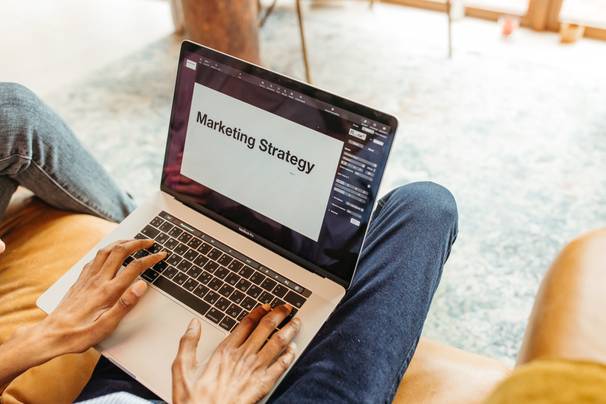 Man with laptop that says marketing strategy