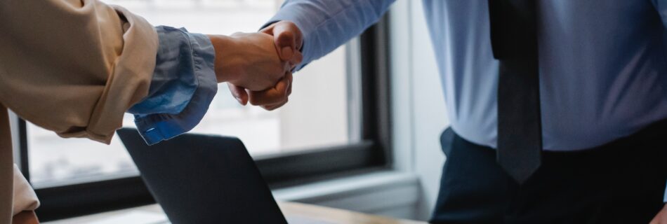 Two men shaking hands in an office