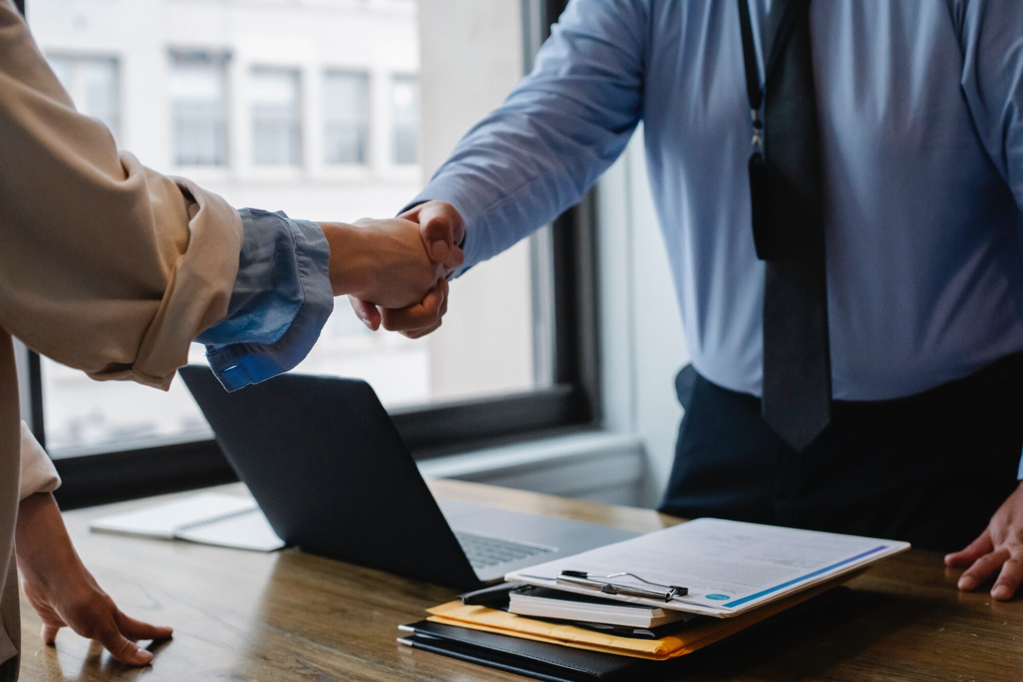 Two men shaking hands in an office